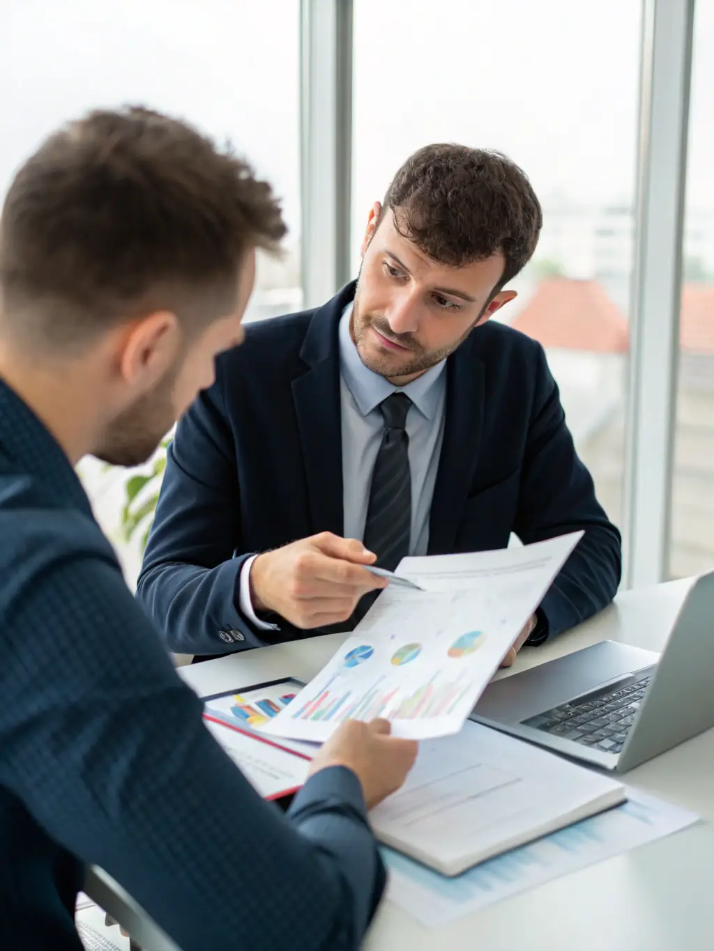 A professional accountant analyzing financial reports on a tablet, showcasing data-driven decision-making for small businesses.